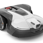 Robotic lawn mower with a visible control panel and large wheel, shown in a studio setting.