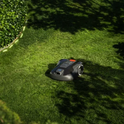 Robotic lawn mower operating in a well-maintained garden.